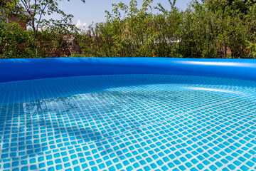 Part of a blue inflatable pool in the backyard of a private house.