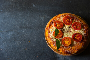 Cheese and tomato pizza on a background with empty space.