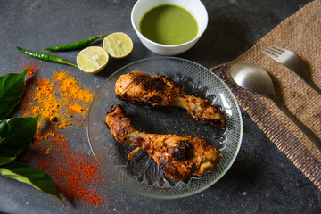 Chicken Tandoori pieces on a plate with all condiments