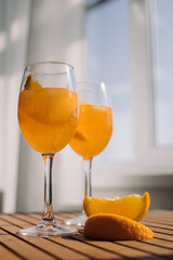 Low angle view of glasses of Aperitif drink on the terrace table. Fresh summer cocktail.