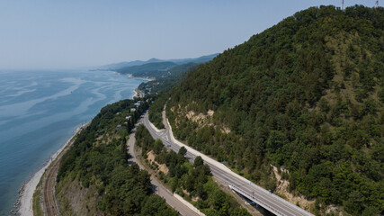 Fototapeta na wymiar Aerial view of high bridge and mountain road with cars and truck, Black Sea, Russia