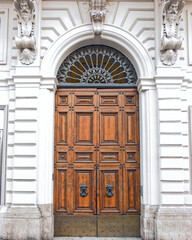 Rome Italy, vintage house entrance natural wood arched door