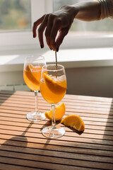 Woman preparing traditional Italian aperitif at home. Relax after work concept.