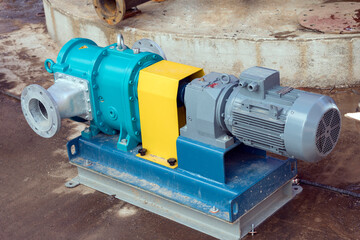 View of the horizontally mounted lobe pump for storage tank. A pump is a device that moves fluids...