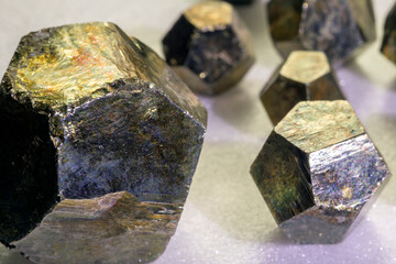 View of the group pyrites. Pyrite is considered the most common of the sulfide minerals. Pyrite's metallic luster and pale brass-yellow hue give it a superficial resemblance to gold.