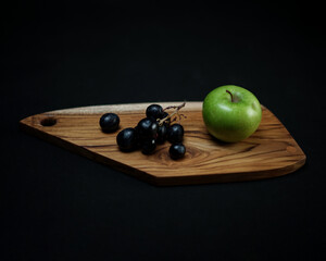 photo of wooden cutting board products and wooden trays, by adding properties to a variety of fresh fruit. Looks very attractive and elegant.