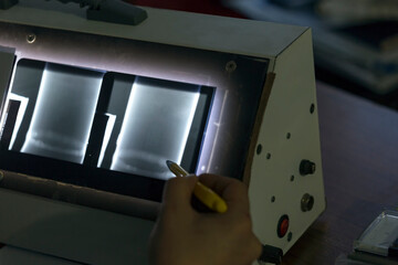 The inspector review weld of the pipe on the radiographic film. Radiography is an imaging technique...