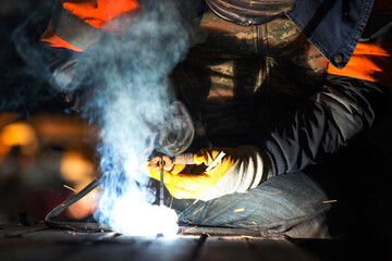 The welder is welding with shielded metal arc welding, manual metal arc welding or stick welding....