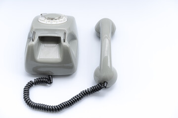 Old disk telephone on a white background