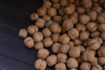 Ripe walnuts on a wooden background