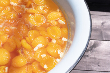 Apricot jam on a wooden background