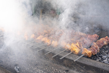 The meat in the smoke is fried on charcoal