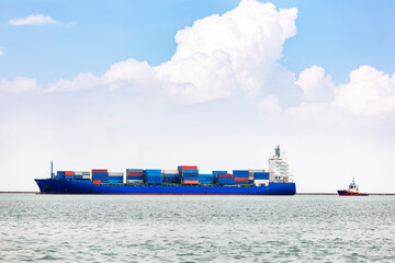 A large container ship and a pilot ship with cloudy, blue sky in Mediterranean Sea. Container ships...