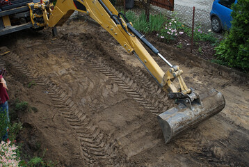 leveling the ground by an excavator on the construction site