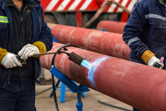 The welder is preheating to pipeline before welding. The phenomenon of heating the joint in the weld zone before the commencement of welding procedure is known as pre-heating.