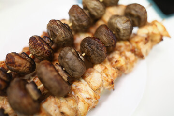 Ready meat on skewers with mushrooms. Cooking at home concept