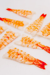 Many big cooked peeled shrimps on white background