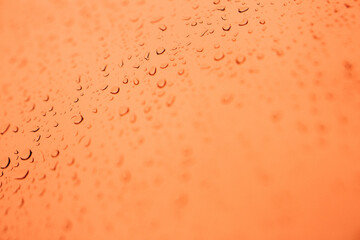Raindrops on window glass,condensation on the window,natural background,color texture,orange abstract and pattern
