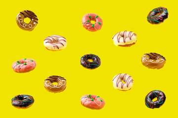 levitation of colored glazed donuts on a bright yellow background. baking concept for a fun children's holiday. selective focus.