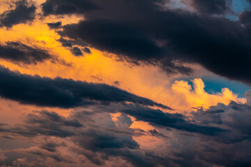 Blurry dramatic colorful cloudscape during Sunset. Dark cloud pattern with copy space for text and background