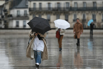 People with an umbrella in a rainy day in Paris