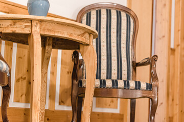 Closeup of a rustic wooden rocking chair and a coffee table