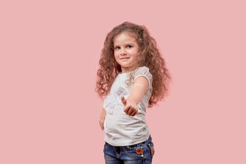 Happy cheerful girl with curly loose white hair showing thumbs up gesture.