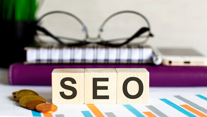 Workword made with wooden blocks and wallet on pink with text SEO