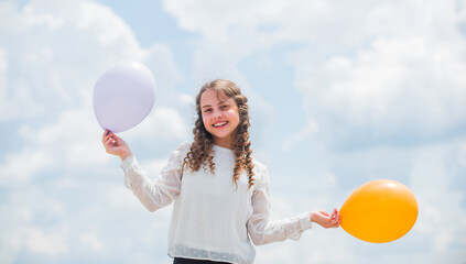 Happy child with colorful air balloons over blue sky background. express positive emotions. just have fun. freedom. summer holidays celebration. international childrens day. Funny idea