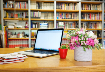 Work from home safely and peacefully in the quarantine period..On the desk, a vase of flowers,...