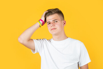 mens beauty standards. urban style. fashion model teen. teen boy wear sport bracelets. young boy in casual style. handsome teen male on yellow background. male barbershop and hairdresser