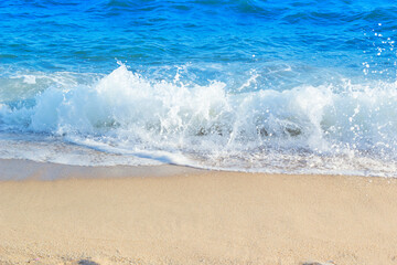 wave of blue ocean on sandy beach. Background.