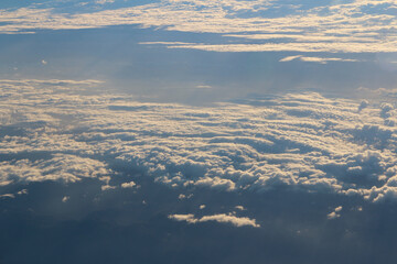Cloud texture and blue sky during sunrise viewed from airplane