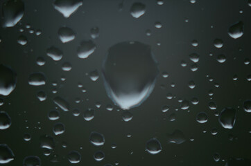 Rain drops on window glasses surface with cloudy background . Natural Pattern of raindrops on cloudy background.
