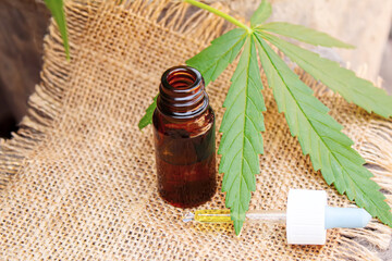 Cannabis essential oil in a small bottle. Selective focus.