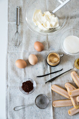 Ingredients for homemade tiramisu: mascarpone cheese, eggs, coffee, vanilla, sugar, cocoa powder and ladyfingers. 
