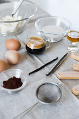 Ingredients for homemade tiramisu: mascarpone cheese, eggs, coffee, cognac, vanilla, sugar, cocoa powder and ladyfingers. 