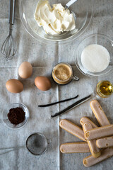 Ingredients for homemade tiramisu: mascarpone cheese, eggs, coffee, cognac, vanilla, sugar, cocoa powder and ladyfingers. 