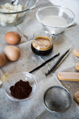 Ingredients for homemade tiramisu: mascarpone cheese, eggs, coffee, vanilla, sugar, cocoa powder and ladyfingers. 