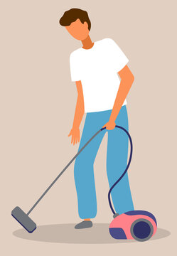 Young guy cleaning floor from dirt with vacuum cleaner. Home everyday activity during quarantine time, spreading covid-19, world epidemic. Isolated character making home work. Housekeeping concept