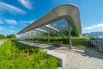 A rest stop in a park in the heart of a modern city.