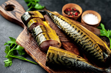
Smoked mackerel on a cutting board on a stone background