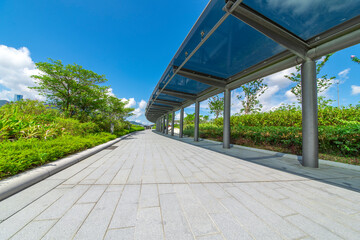 Glass shade corridors in modern parks under the blue sky and white clouds.