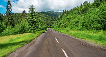 Old asphalt road in a mountain forest.