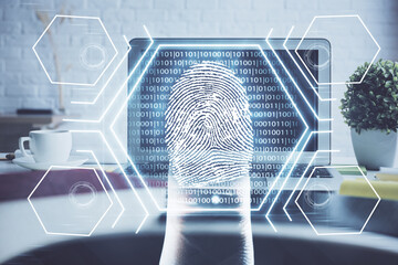 Computer on desktop in office with finger print drawing. Double exposure. Concept of business data security.