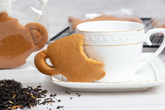 Cookies with black tea on the background