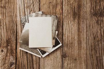 Old vintage photo template (mockup) on wooden background. Empty retro card, textured paper.
