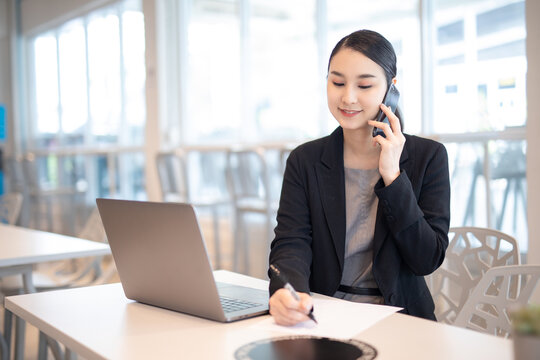 Asian girl with laptop, success happy pose. E-commerce, University education, internet Technology, or startup small business concept. Modern office or living room with copy space
