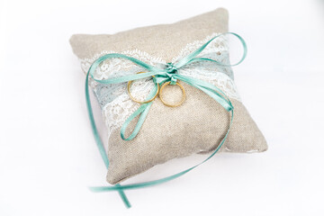 
wedding rings on a pillow