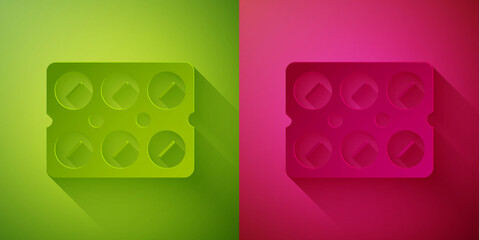 Paper cut Pills in blister pack icon isolated on green and pink background. Medical drug package for tablet, vitamin, antibiotic, aspirin. Paper art style. Vector Illustration.